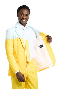 A man in a Suitmeister Premium Beer Yellow ensemble, featuring a captivating gradient from light blue to yellow, holds open the front of his jacket, showcasing its white interior. He's dressed in a white shirt and tie, smiling against a plain backdrop.