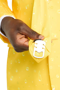 A person dressed in a Suitmeister Premium Beer Yellow suit is holding a necktie that features a built-in bottle opener at the tip. The suit and tie boast playful designs with subtle patterns, all set against a plain white background.