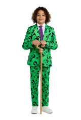 A person with curly hair is dressed in "The Riddler costume" Suitmeister suit, featuring a vibrant green design adorned with black question marks. The ensemble is completed with a purple tie and white shoes, as the individual confidently holds a wooden cane.