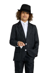 A child confidently stands holding a cane, dressed in Suitmeister's Gangster Pinstripe Black suit with white buttons, complemented by a white shirt and black hat against a white background.