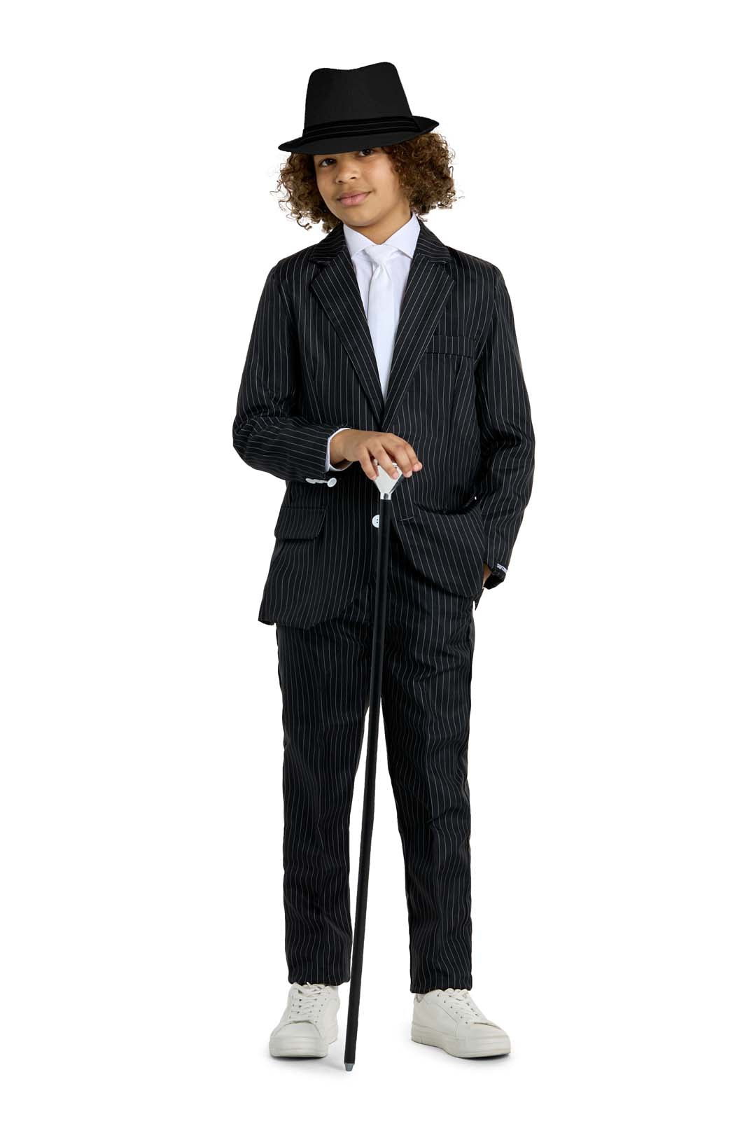 A child dressed in the Suitmeister Gangster Pinstripe Black suit, featuring a white shirt and black hat, stands confidently. They hold a black cane and sport white sneakers against a plain white background.