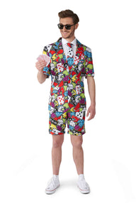 In the Carnival suit from Suitmeister's Casino Icons collection, a man wearing shorts and a tie holds a fan of playing cards. He's styled with sunglasses and white sneakers, posed against a plain white backdrop.