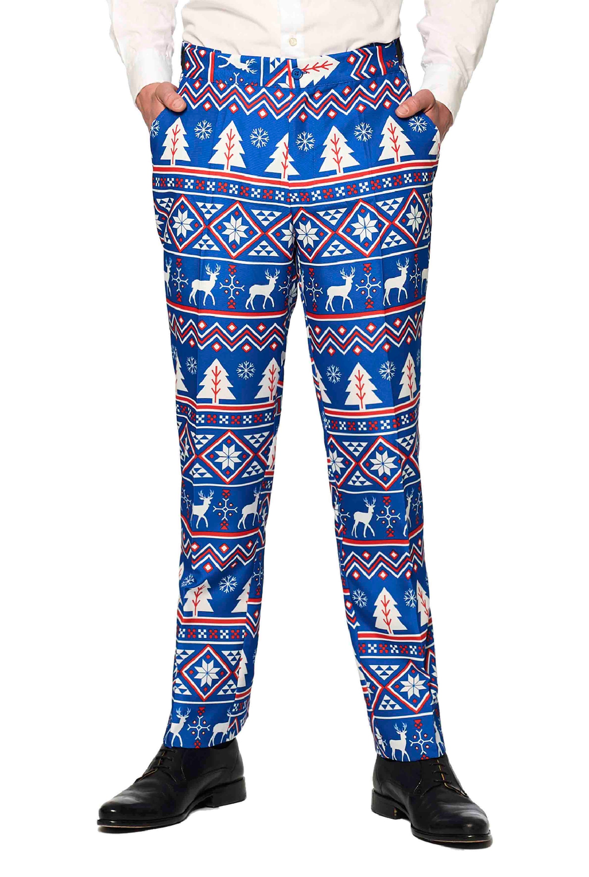 A person is wearing the Christmas Suit Blue Nordic by Suitmeister, featuring a winter-themed pattern with reindeer, snowflakes, and trees. They are also wearing black shoes and only the lower half of their body is visible.