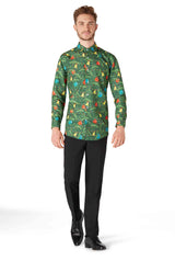 A man wearing a Christmas Green Tree Shirt from Suitmeister, featuring a jungle-themed design with colorful animals and foliage, paired with black pants and shoes, standing against a white background.