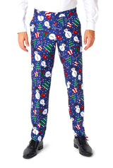 A person wearing the Suitmeister Christmas Snowman Blue pants, detailed with snowmen, candy canes, Christmas trees, and snowflakes. They have paired them with a white shirt and black shoes.