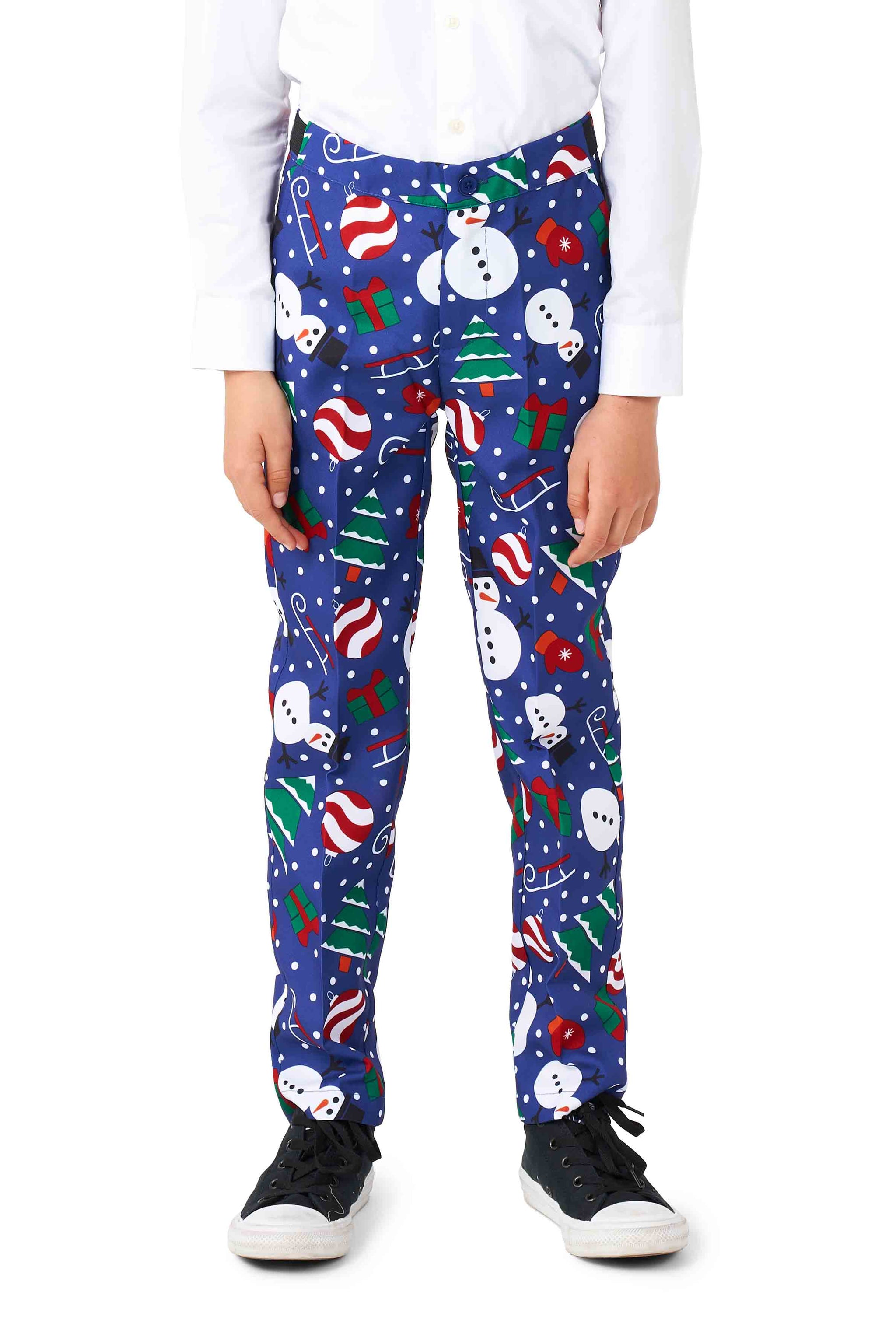 A child wearing the Suitmeister's Christmas Snowman Blue pants, decorated with snowmen, Christmas trees, candy canes, and gift patterns. They are also wearing a white shirt and black sneakers.