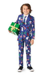 A child wearing the Suitmeister Christmas Snowman Blue suit, adorned with snowman and candy cane patterns, holds a green gift box tied with a gold ribbon. They are smiling and wearing black shoes.