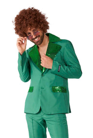 A person with curly hair wears the Disco Suit Green by Suitmeister, showcasing its retro style with sequined lapels and pocket accents. They are smiling and adjusting their sunglasses.