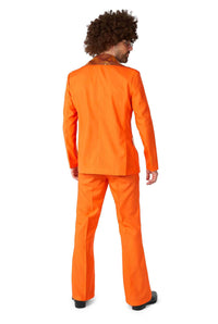 A person sporting the Disco Suit Orange by Suitmeister, complete with a curly wig and black shoes, stands facing away against a plain white background, showcasing the ensemble from behind.