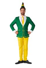 A man dressed in the Suitmeister's Elf™ - Christmas Suit Elf dons a green jacket adorned with yellow floral designs, paired with yellow pants, a white shirt, and a coordinating yellow tie. Completing the look is his green elf hat featuring a red feather. He stands confidently with hands on hips and smiles broadly.