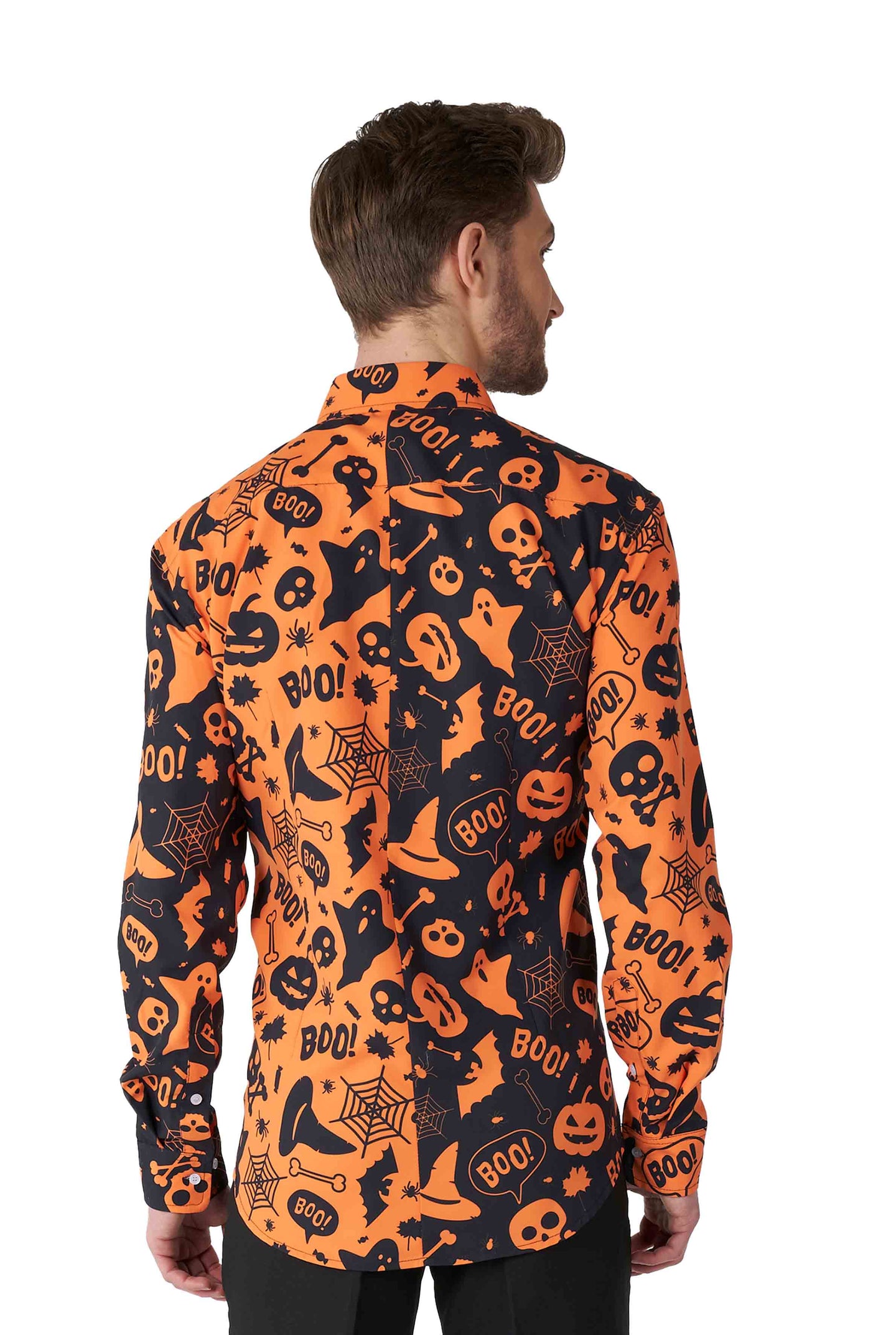 A person is turned away, dressed in the Suitmeister Halloween Icons shirt featuring an array of Halloween-themed designs such as ghosts, pumpkins, and the word "BOO!" scattered across in orange and black. The shirt is long-sleeved and paired with black pants.