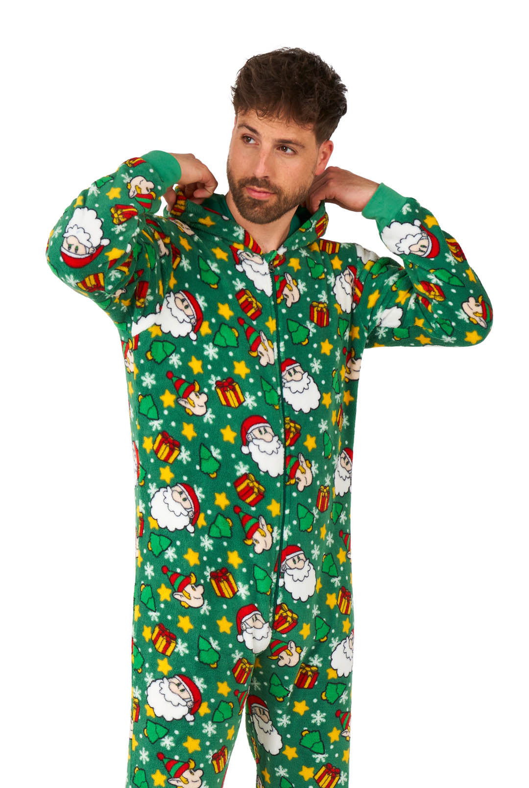 A person adjusts the hood of the Suitmeister Santa Elves Green onesie, which is adorned with playful Christmas-themed prints, including Santa Claus, gifts, and stars. The onesie boasts a festive and cozy design perfect for the holiday season.