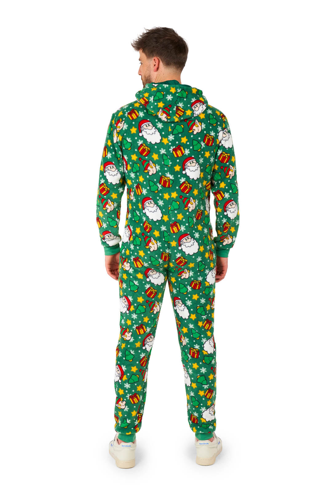 Someone is wearing the Suitmeister Santa Elves Green - Christmas onesie, adorned with snowmen, Christmas presents, and stars. This hooded outfit is paired with white sneakers as the person stands facing away.