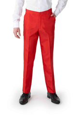 A person wearing the vibrant Santa Faux Fur pants from Suitmeister, along with a white shirt and black shoes. Their right hand rests in the pant pocket while standing against a plain white background. The image is cropped just above the waist, focusing on the lower part of their outfit.