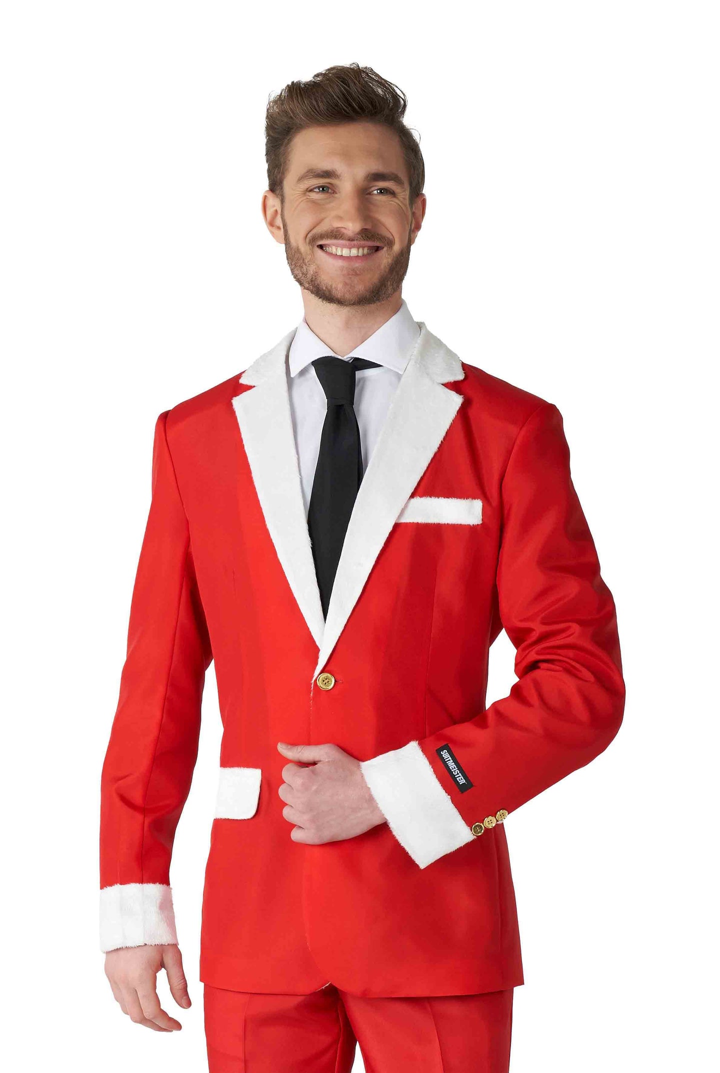 A man wearing the Suitmeister Santa Faux Fur - Santa Christmas suit is dressed in a festive, holiday-themed outfit with red fabric and white trim. He complements the look with a white shirt and black tie, smiling warmly with his short hair styled neatly.