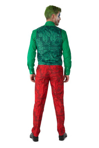 A person with green hair, dressed in a green shirt and a pair of Suitmeister's Scarlet Joker™ red pants featuring comic patterns, stands with their back to the camera.