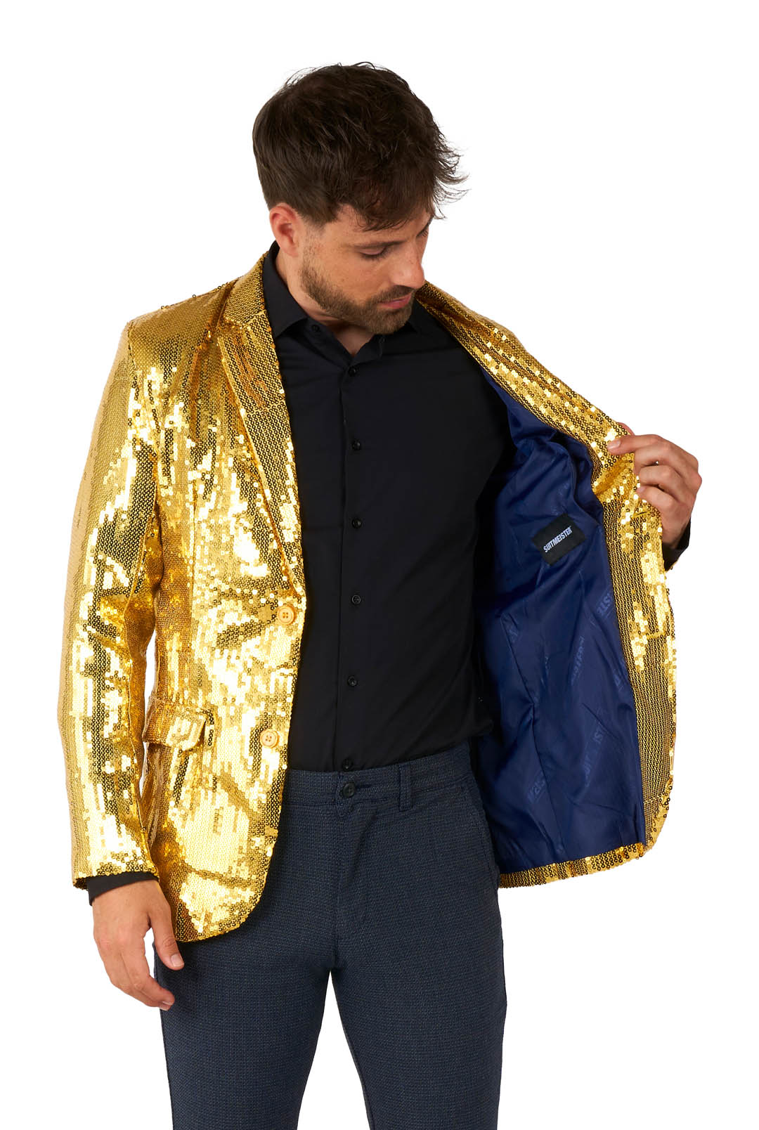 A man wearing a Suitmeister Sequins Blazer Gold over a black shirt and blue pants, inspecting the inside of the open jacket.