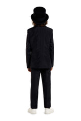 A person with shoulder-length hair is standing with their back to the viewer, wearing a Suitmeister Skeleton Grunge Black suit and a top hat. They are also sporting white sneakers against a plain white background.