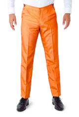 A model showcasing the vibrant Solid Orange Suit by Suitmeister, complemented with a white long-sleeve shirt and black shoes, against a plain white backdrop. The image emphasizes the pants and lower section of the ensemble.