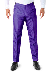 A person wearing vibrant **Suitmeister Solid Purple** pants stands facing forward. They have a white shirt tucked in and are wearing black shoes. The pants have a slight sheen and feature a classic fit design.