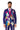 A man with a beard is dressed in the vibrant Sugar Skull Purple suit by Suitmeister. The suit features colorful floral patterns and a skeleton design on a purple backdrop. He complements his outfit with a bright pink tie while standing against a plain white background.