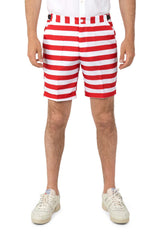 A person wearing knee-length USA Flag shorts featuring red and white stripes from Suitmeister stands with their hands by their sides. The outfit is complemented by white sneakers against a plain white background.