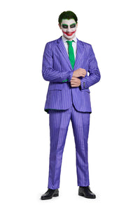 A person wearing The Joker costume by Suitmeister stands against a white background, dressed as a clown-like character with a painted face, in a purple pinstripe suit paired with a green shirt and tie, adjusting the sleeve of the suit jacket.