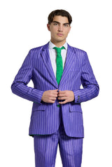 A person wearing "The Joker" purple pinstripe suit with a green tie from Suitmeister stands against a white background, buttoning the jacket and gazing at the camera.