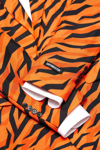 Close-up of the Tiger Orange suit by Suitmeister, featuring an orange and black tiger-striped pattern with visible white shirt cuffs and a branded Suitmeister label on the sleeve, complete with bold, striking patterns and multiple buttons.