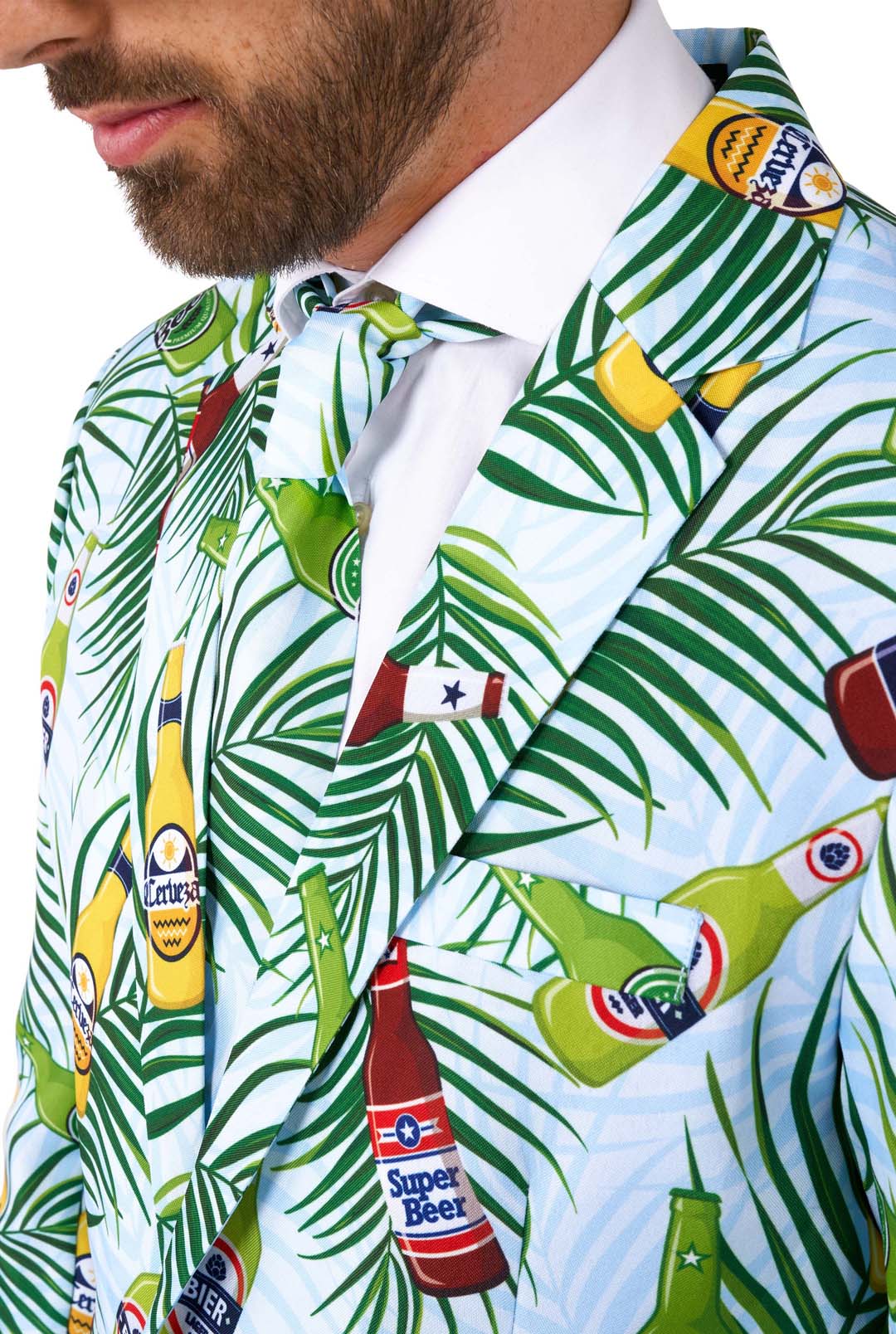 Close-up of a man wearing the Suitmeister's "Tropical Beers Blue," a suit displaying colorful illustrations of various beer labels and palm leaves set against a light blue background.