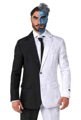 A man stands wearing the Suitmeister's Two Face costume. His face exhibits a dual theme: one side remains natural while the other is painted blue with a menacing expression. His hair mirrors this dual-color scheme.