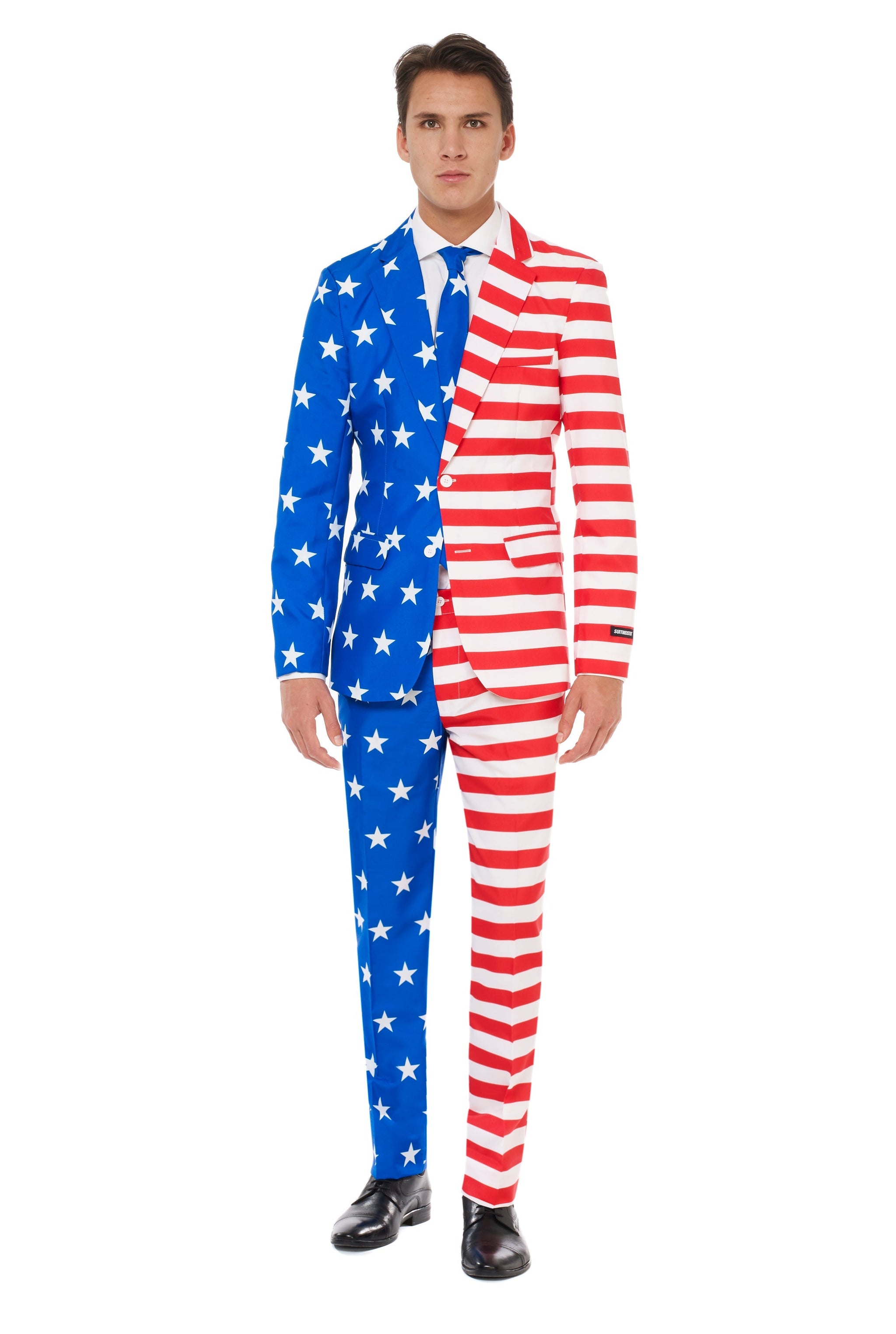 A person wearing Suitmeister's USA Flag suit, which features a distinctive design with one half in blue adorned with white stars and the other half in red and white stripes, resembling the American flag. They stand against a plain white background.