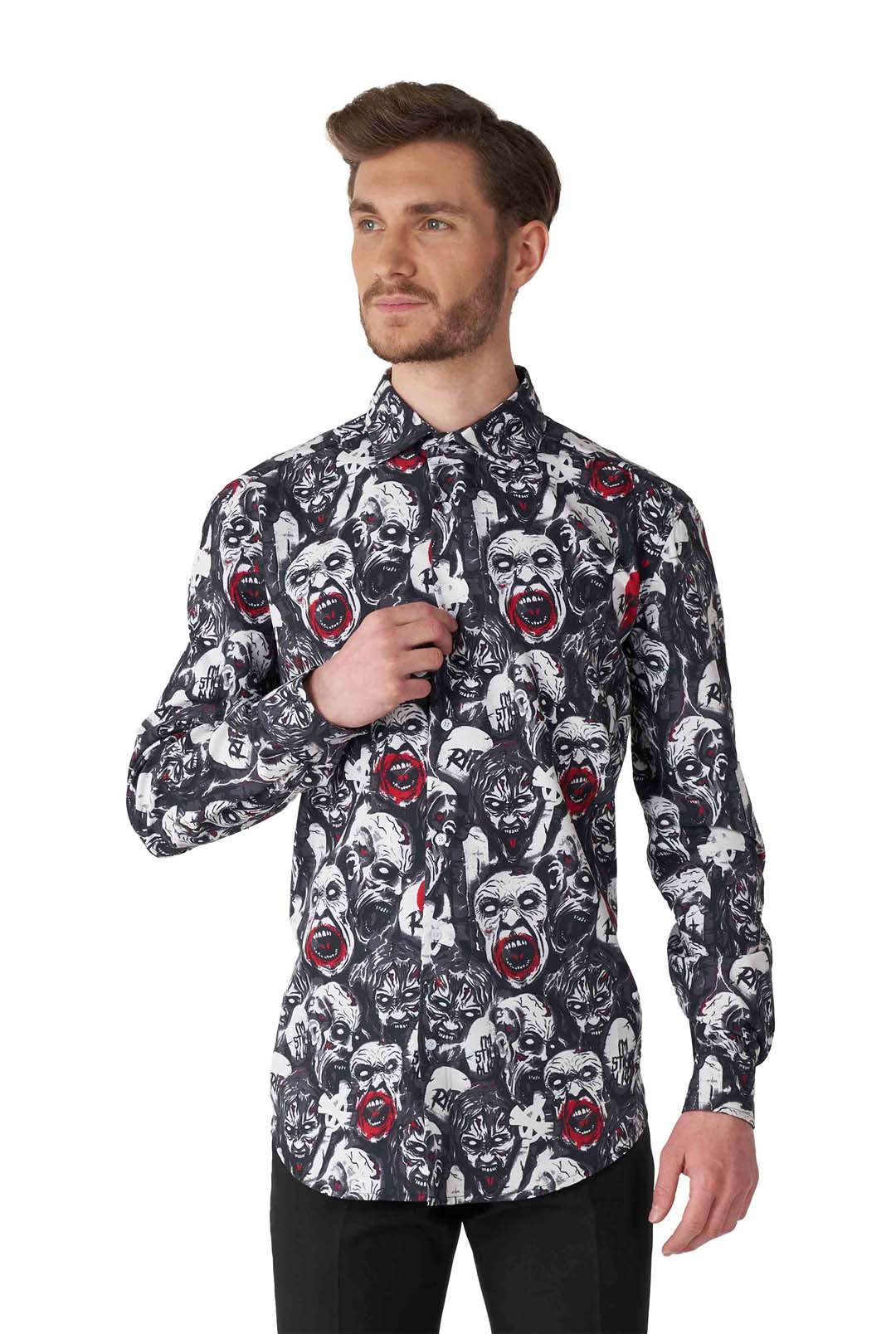 A man with a beard wearing a button-up shirt from Suitmeister. The 'Zombie Characters - Zombie shirt' features a striking monochrome pattern of illustrated faces with red accents. He stands against a plain white background, adjusting the collar of his shirt.