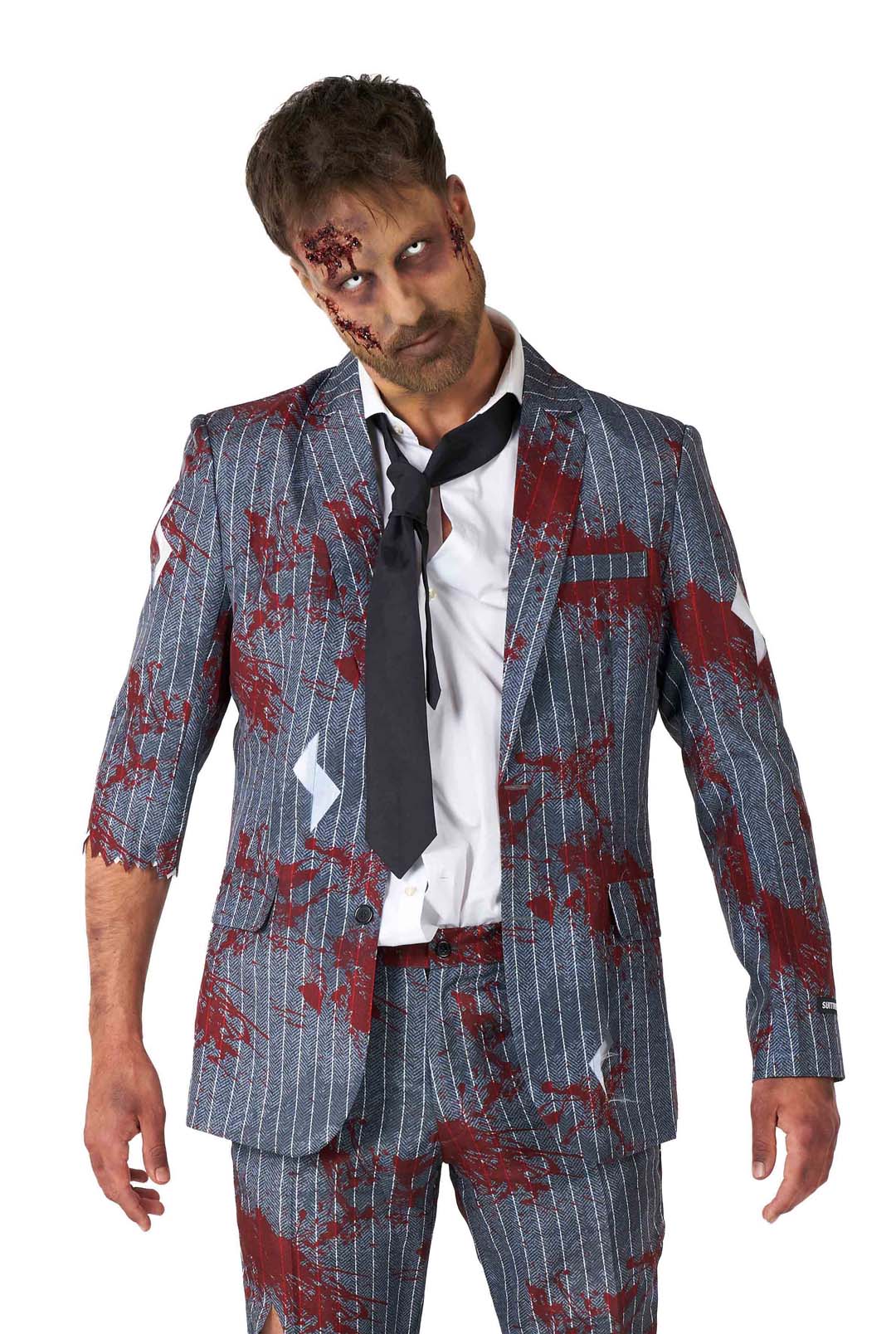 Wearing Suitmeister's Zombie Grey costume, an individual dons a tattered pinstripe suit with a white shirt and loosened tie. Accompanied by zombie makeup—with fake wounds and discolored skin—they display a vacant expression that captures the essence of classic horror against a plain background.